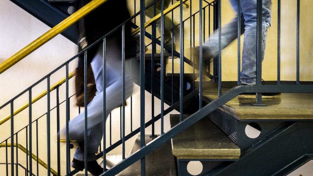 People going up the stairs at the School of Social Work, Lund University.